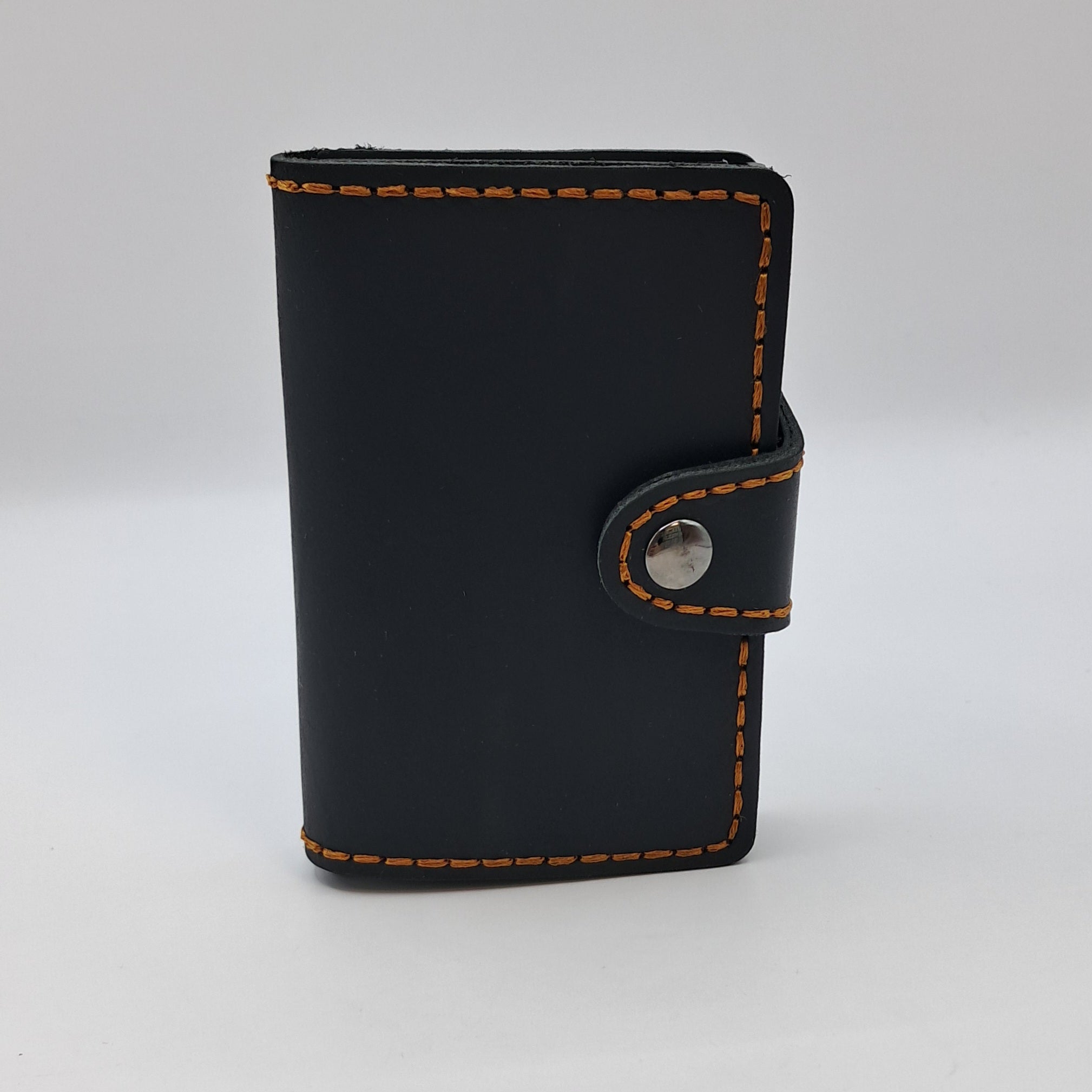 Billetera de cuero genuino, estilo tarjetero de doble hoja con broche.