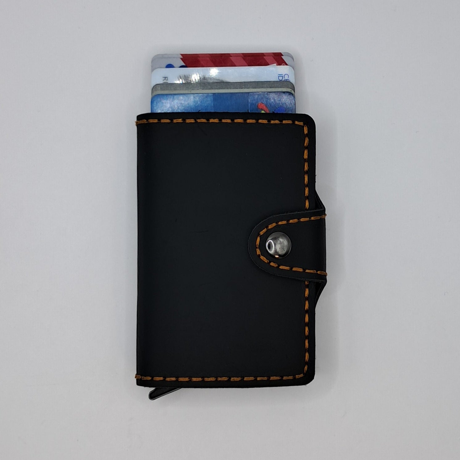 Billetera de cuero genuino, estilo tarjetero de doble hoja con broche.